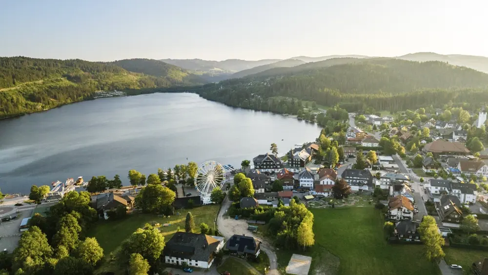 View over Titisee, the lake and the Ferris wheel