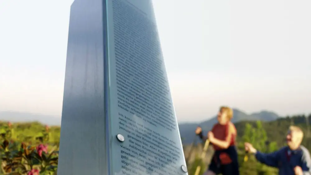 Wanderer betrachten eine der sechs Stelen am Sebaldweg in Wertach