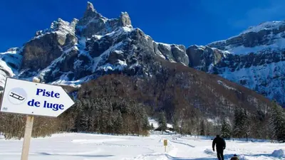 Vater mit Kind auf dem Weg zur Rodelbahn