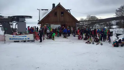 Personen vor der Skihütte in Sehmatal-Neudorf