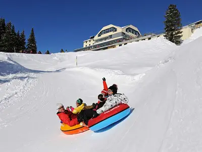 Wintersportler rutschen in riesigen Reifen die Piste im Rutschpark Trübsee herunter © Engelberg-Titlis Tourismus AG