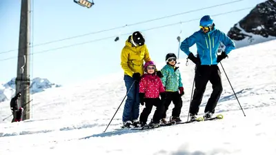 Eltern mit zwei Kindern beim Skifahren in Gargellen