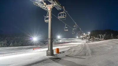 Beleuchtete Piste und Sessellift beim Nachtskilauf in Leutasch