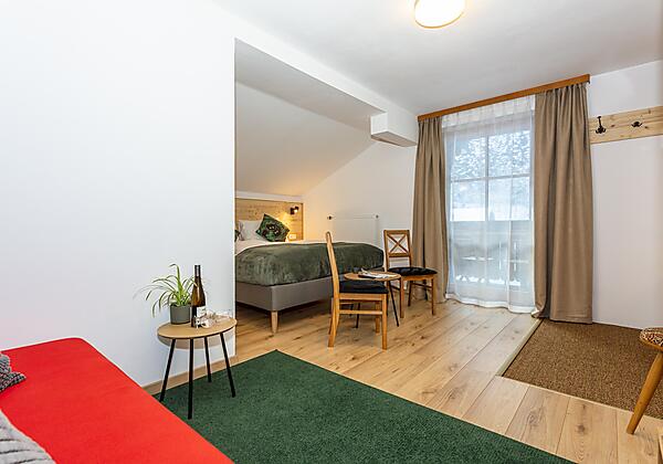 Dreibett Zimmer mit Badewanne und Balkon